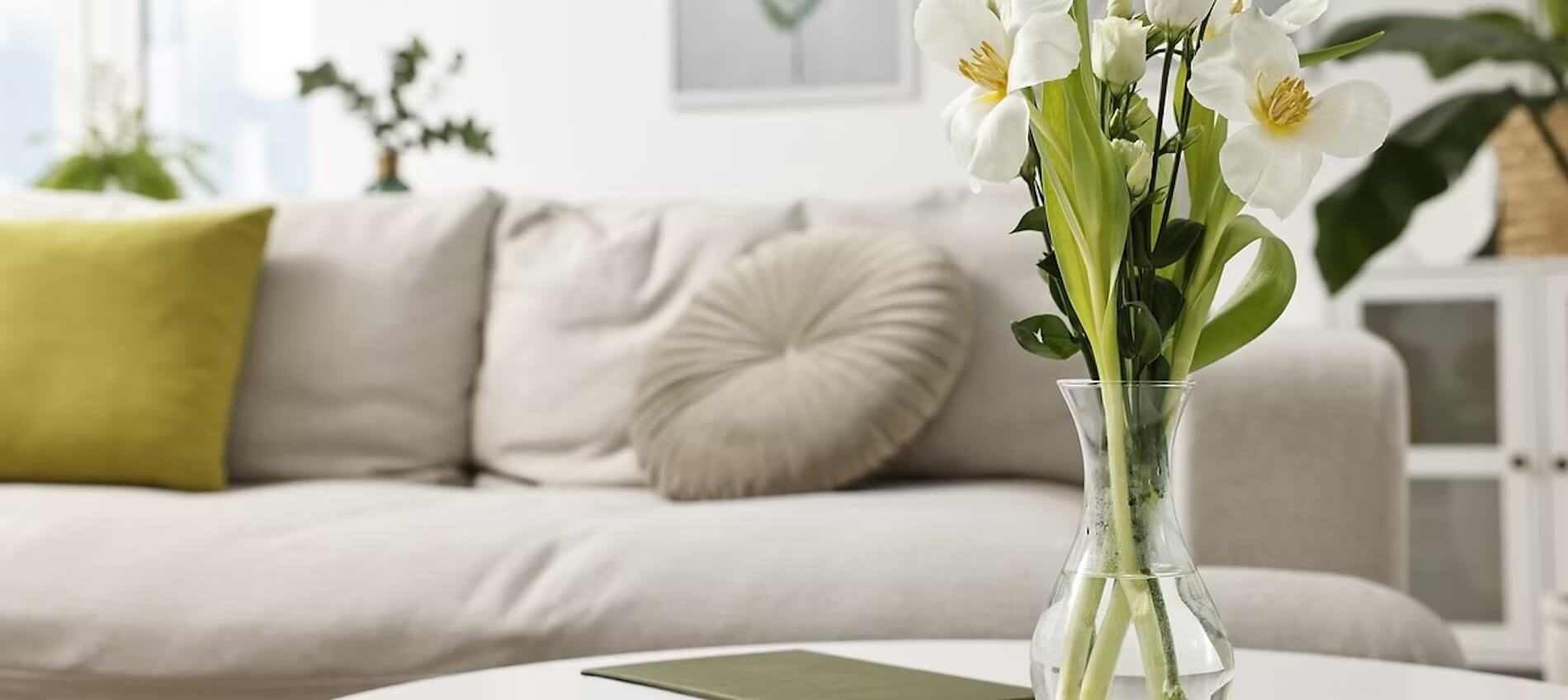 photo of bouquet of flowers on center table with sofa in the background